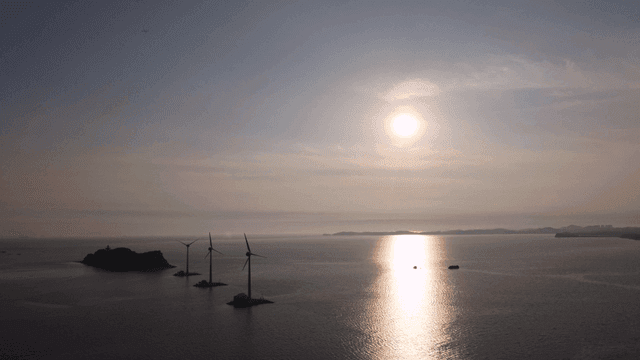 Wind turbines on the sea at sunset