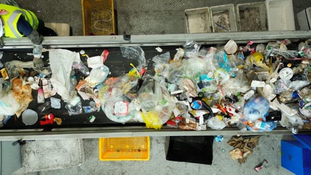 Workers at a recycling center sorting plastic waste