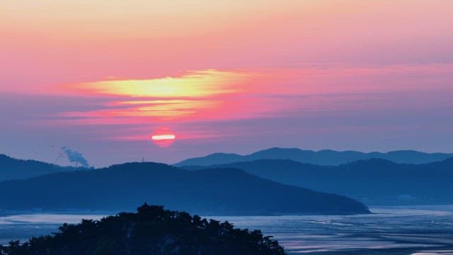 Majestic Sunset Overlapping Hills and Water