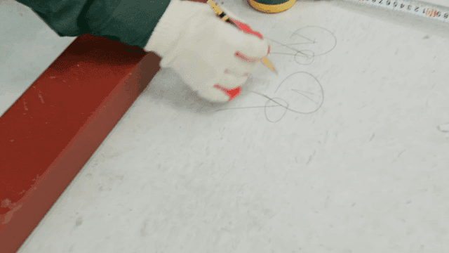 Worker measuring and marking on the floor