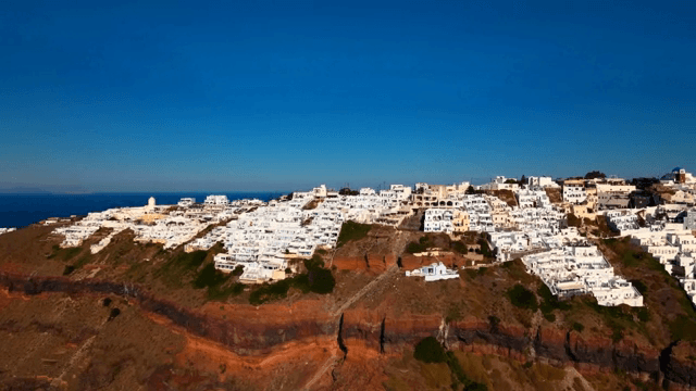 White buildings on a cliff by the sea