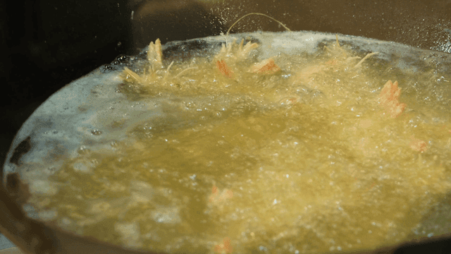 Shrimp being deep-fried in hot oil