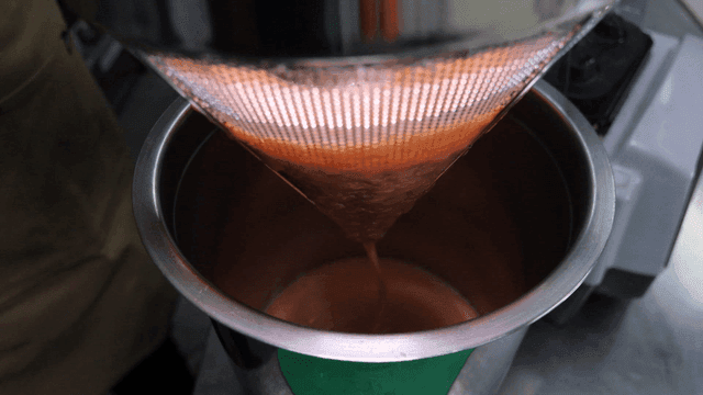 Ground tomato juice filtered in kitchen