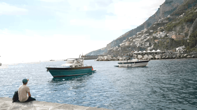 Scenic coastal view with boats and hills