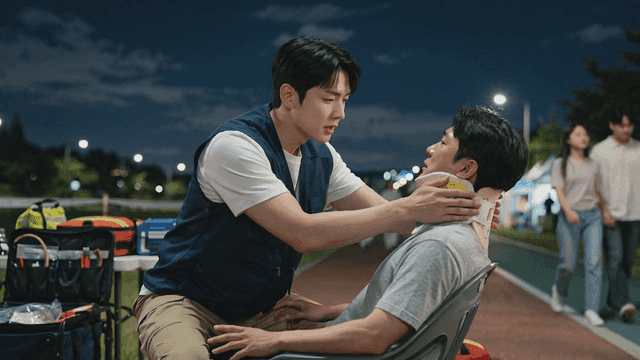 Man receiving first aid in park at night