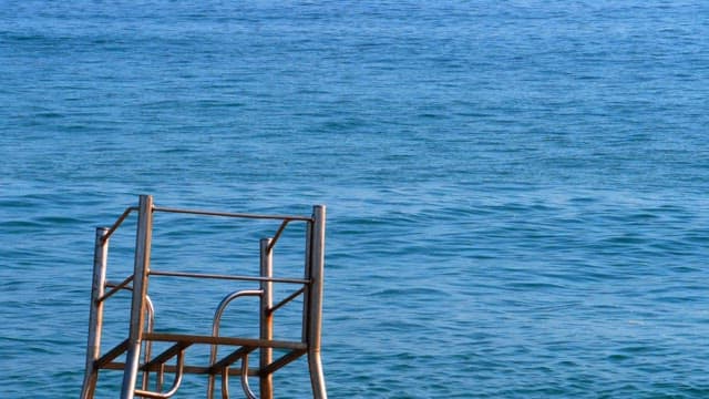 Calm and blue sea with metal structures visible