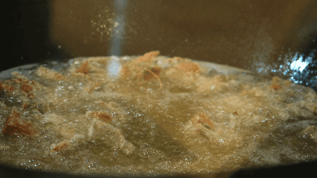 Shrimp fried in hot oil in pan