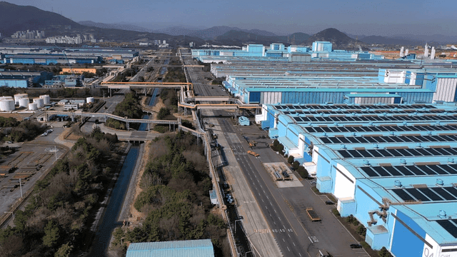 Large industrial complex with blue roofs