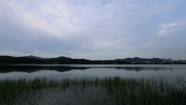 Wide river under cloudy sky