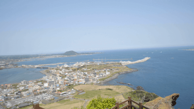 View of coastal village with views of sea and islands