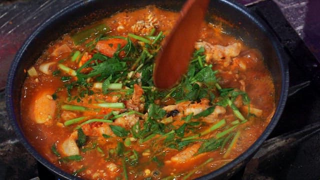 Spicy shaggy sea raven stew boiling in a pot