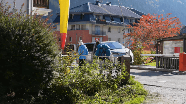 Two travelers walking through scenic village