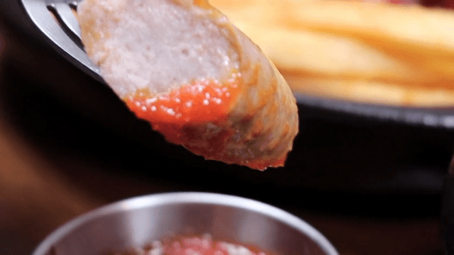 Sausage dipped in tomato sauce