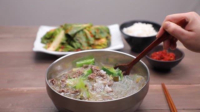 Spoonful of rice in savory yukgaejang with green onions