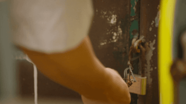 Person touching rusty lock