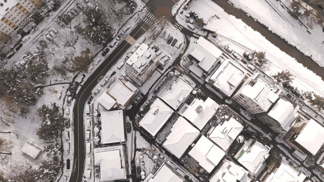 Snow-covered city buildings and streets