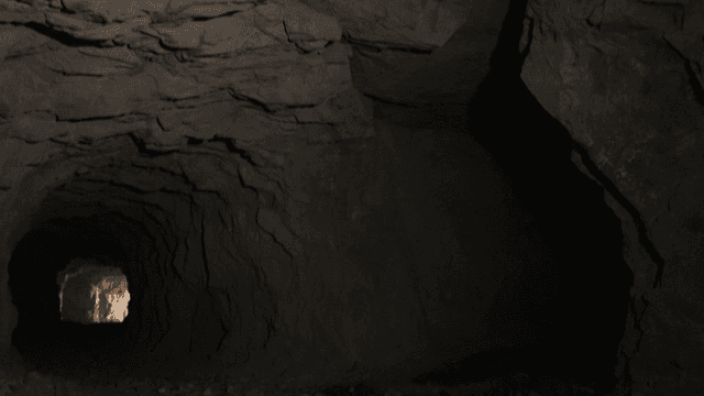 Inside a dark cave with rocky walls