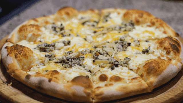 Freshly baked cheese Quattro Formaggi pizza