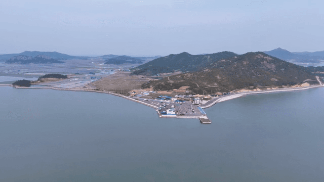 Coastal village with surrounding hills