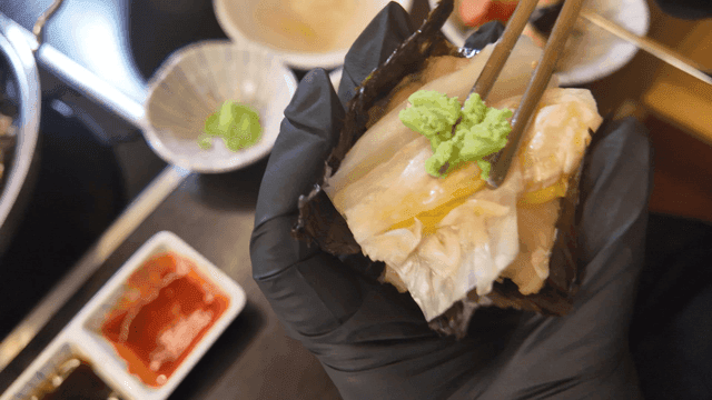 Seaweed topped with white kimchi served with seaweed and wasabi