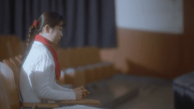 Woman sitting in empty theater seats