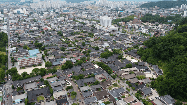 Traditional Korean village with modern cityscape