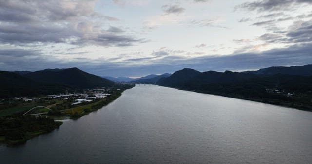 Wide river flowing between mountains