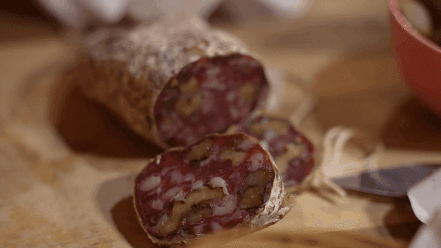 Sliced sausage on a wooden board