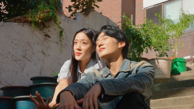 Couple sitting on outdoor steps in sunlight