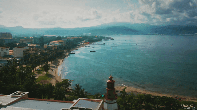 Tropical coastal town with lighthouse and beach