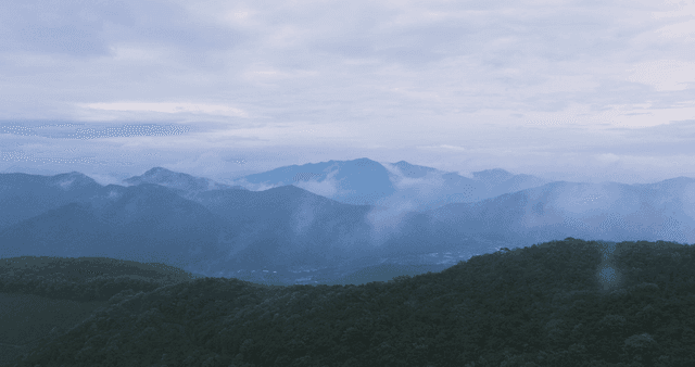 Misty mountains under a cloudy sky