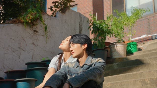 Couple sitting on outdoor steps in sunlight