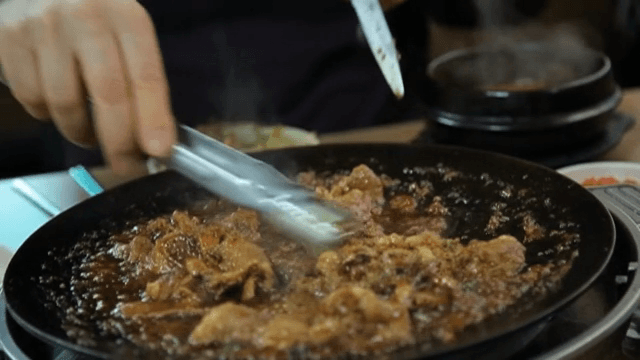 Marinated galbi sizzling over a hot pan