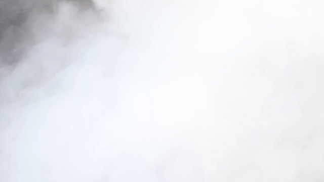 Worker operating steaming popcorn machine