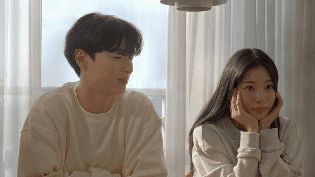 Happy couple smiling by the morning window