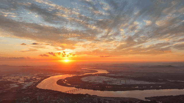 Sunset over a winding river and fields