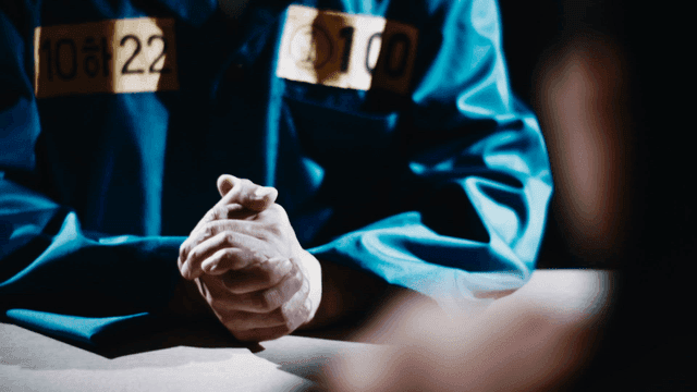 Prisoners and investigators sitting at table