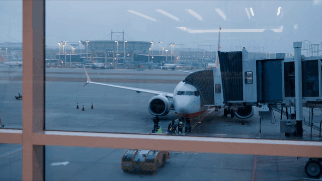 Airplane at the airport gate during dawn