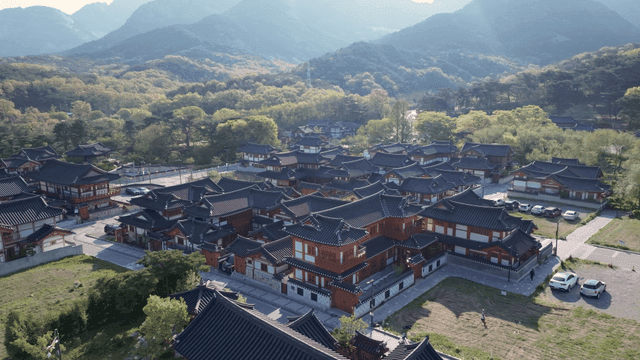 Hanok village beneath sunlit mountain