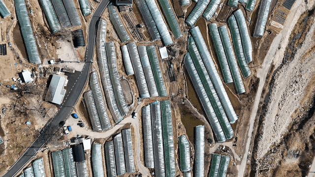 Aerial view of rural area with clustered greenhouses