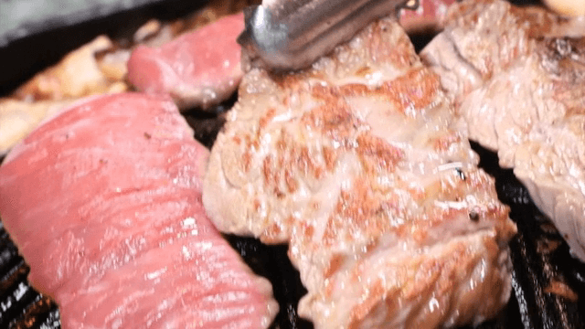 Juicy lamb grilling on a hot pan