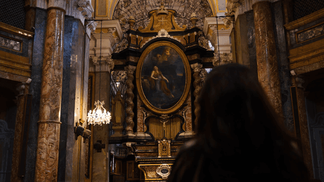 Back view of woman admiring painting in cathedral