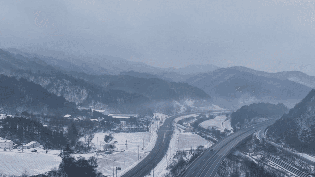 Snowy mountain landscape with winding roads