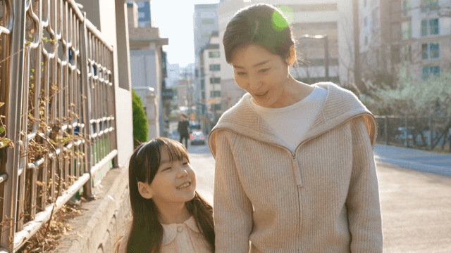 Child walking home from school with her mother
