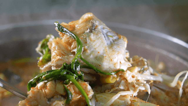 Fish stew boiling with vegetables