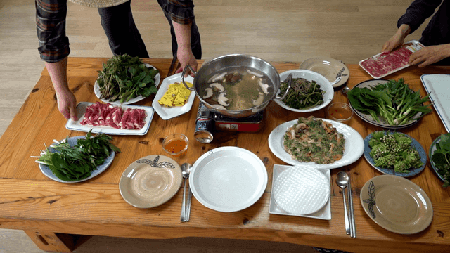 Table set with shabu-shabu dishes and ingredients