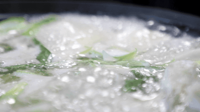 Boiling seafood soup with green onions