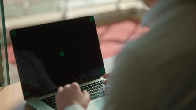 Person Using a Laptop by Sunny Window