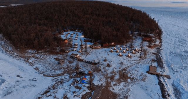 Snow-covered village by a frozen lake