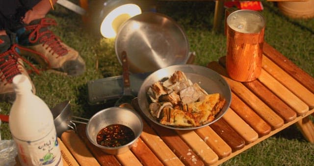 An evening meal outdoors with savory dishes